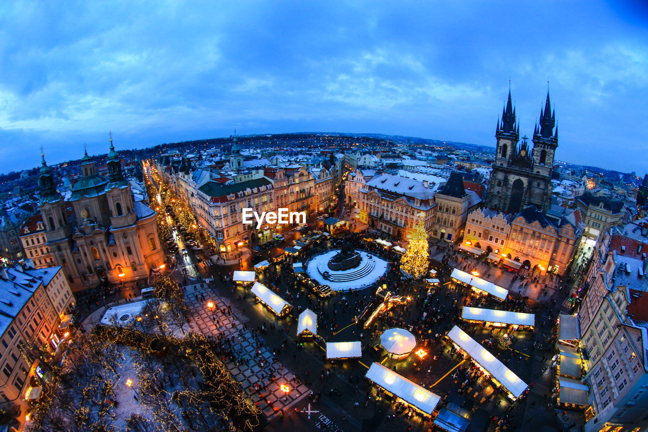HIGH ANGLE VIEW OF ILLUMINATED CITY AT NIGHT