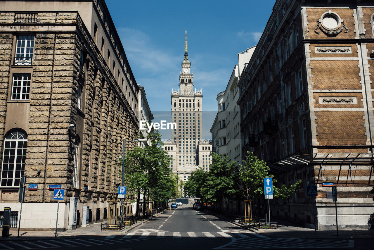 Street amidst buildings in city against sky