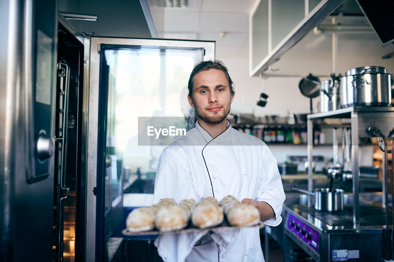 Portrait of chef baking breads in commercial kitchen