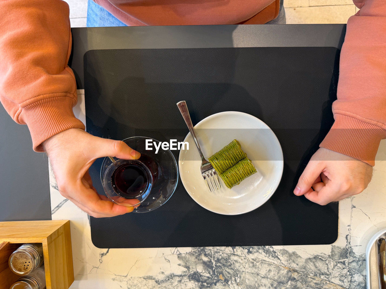 food and drink, food, adult, indoors, one person, healthy eating, wellbeing, cooking, high angle view, lifestyles, drink, table, women, household equipment, freshness, kitchen, domestic room, refreshment, domestic life, domestic kitchen, hand, bowl, holding, fruit, meal, home, kitchen utensil