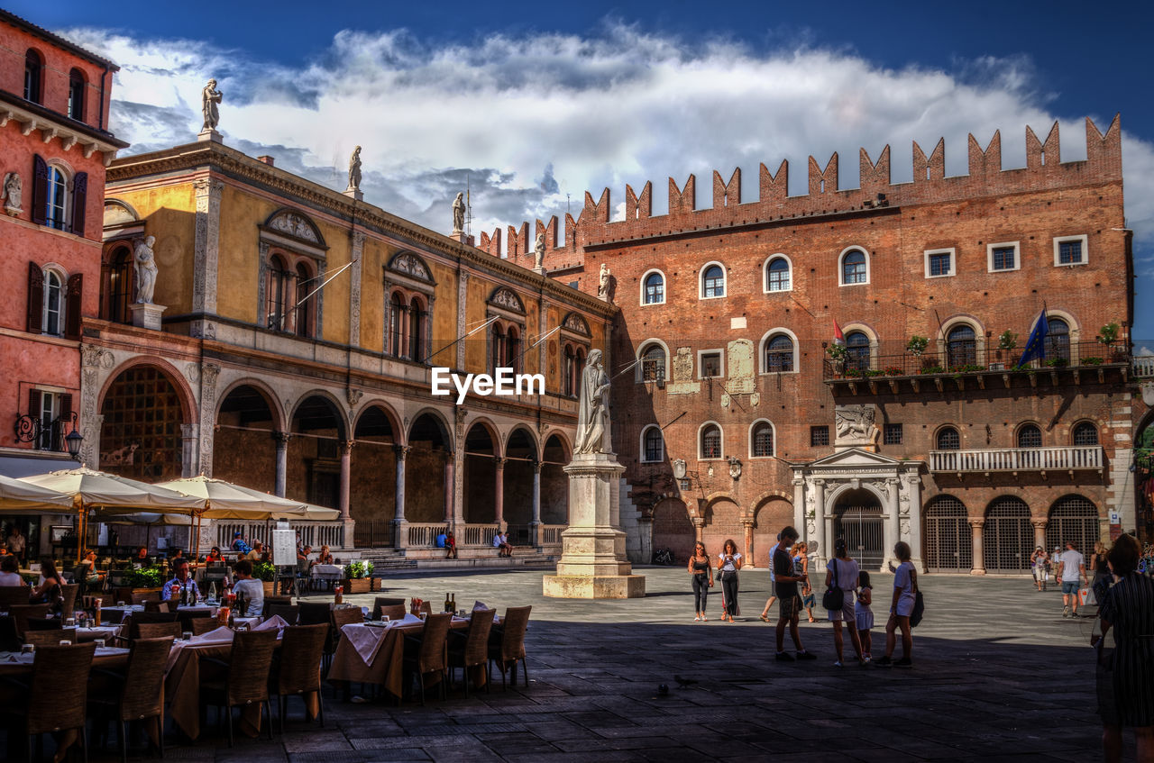 People by historic buildings in town