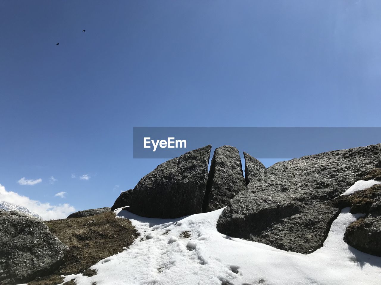 Low angle view of rock formation against sky