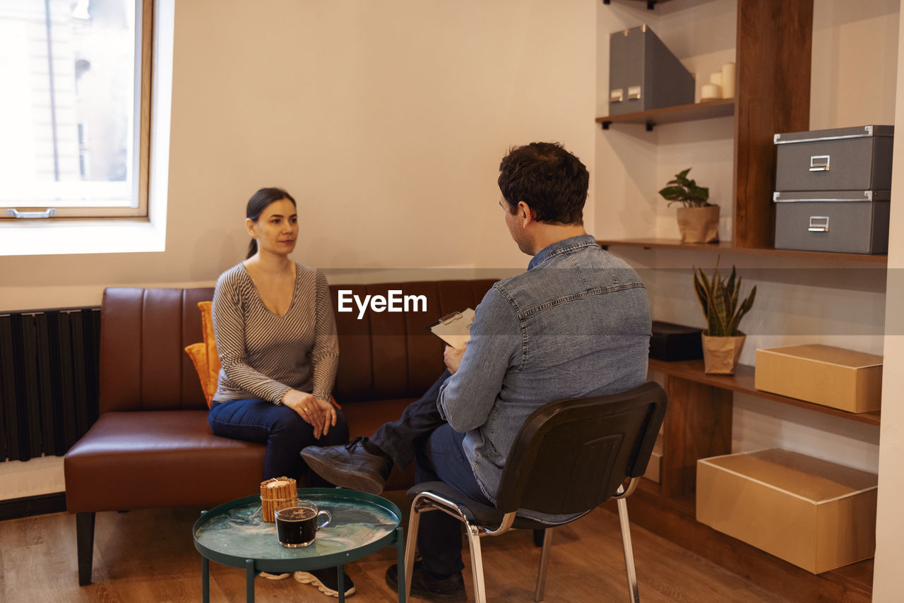 portrait of family sitting on sofa at home