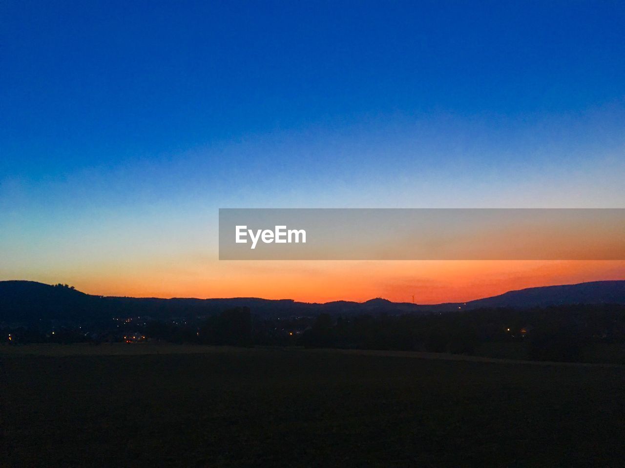 SILHOUETTE LANDSCAPE AGAINST CLEAR SKY DURING SUNSET