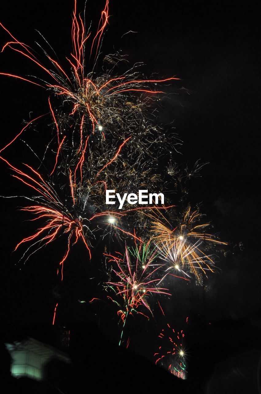 LOW ANGLE VIEW OF FIREWORK DISPLAY IN SKY