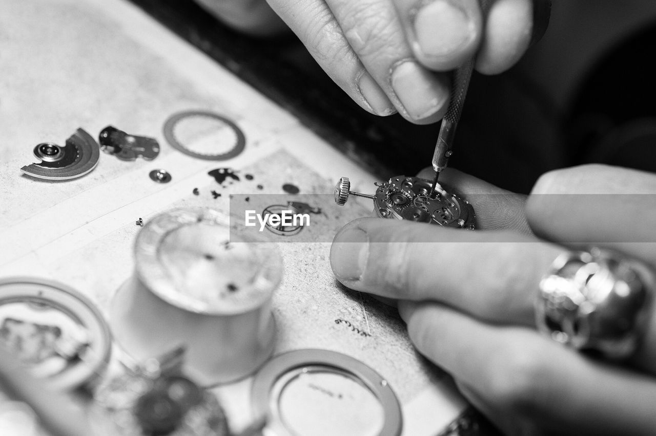 Hands repairing pocket watch