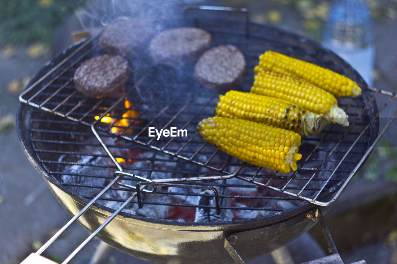 High angle view of corns on barbecue grill