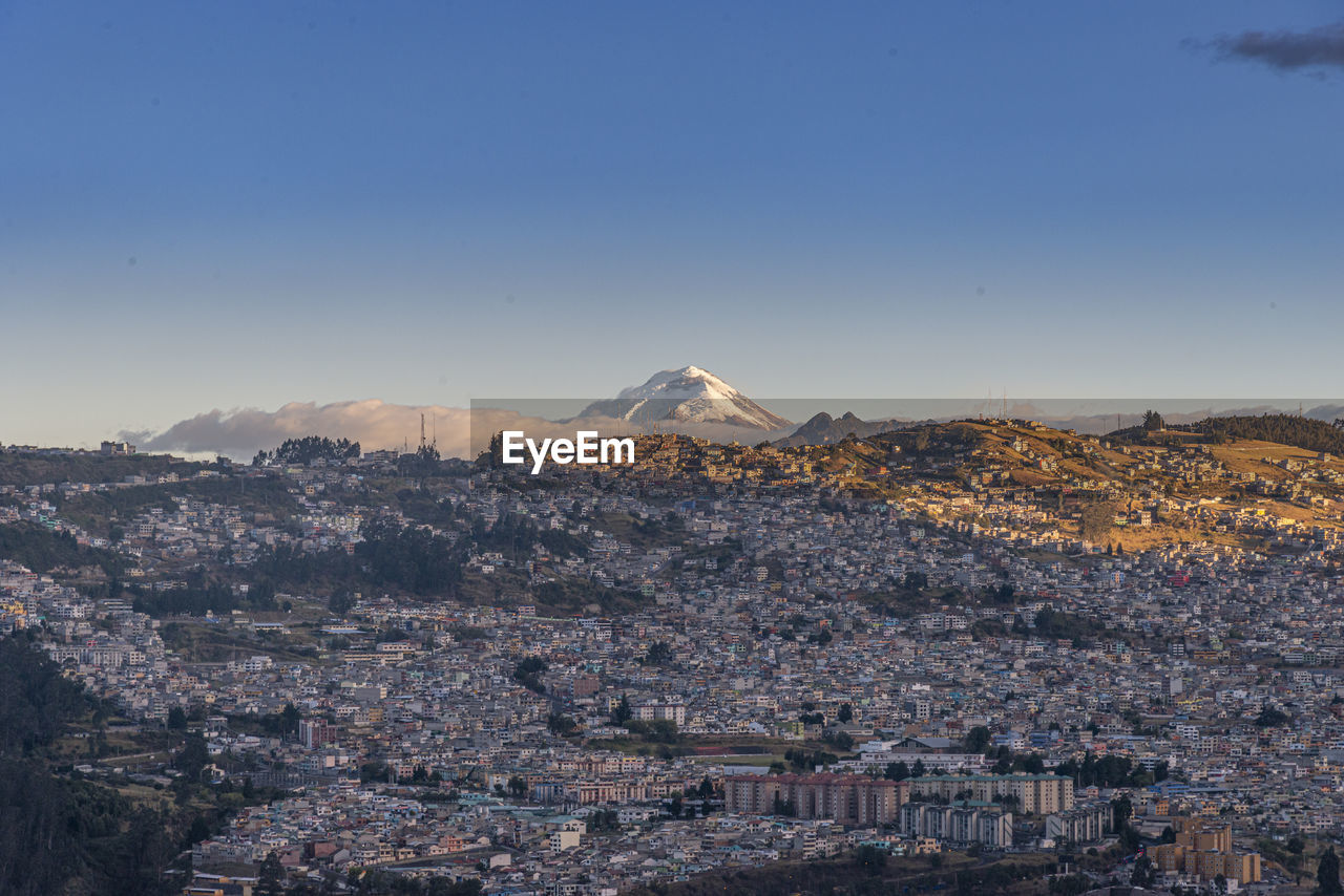 High angle view of cityscape against blue sky