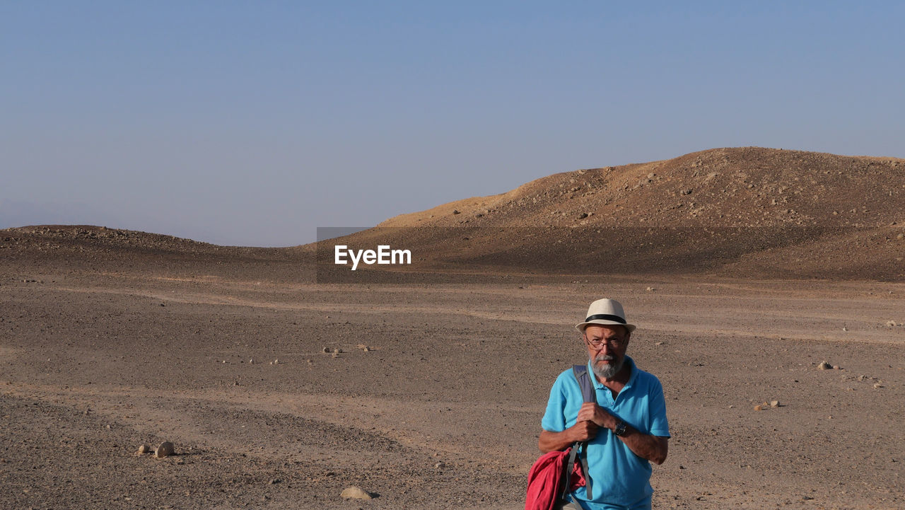 Senior man walking in the desert 