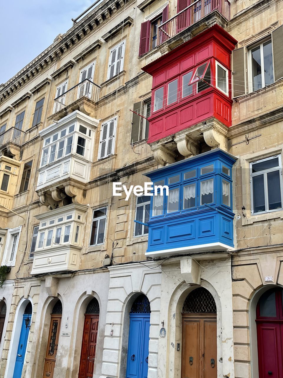 Low angle view of old building colorful balconies