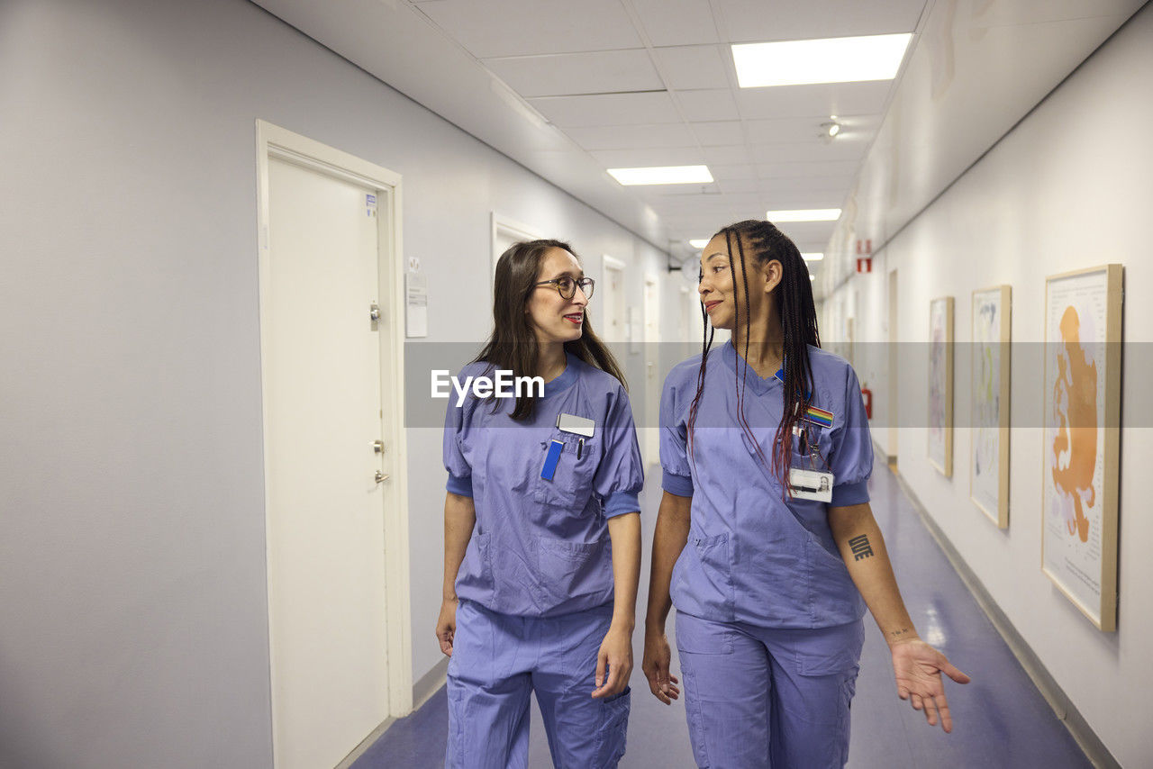 Female doctors talking in hospital corridor