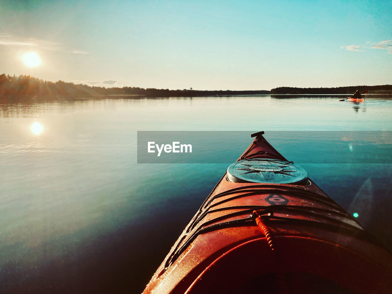 scenic view of lake against sky at sunset