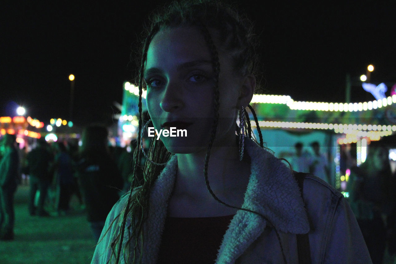 Close-up portrait of young woman in city