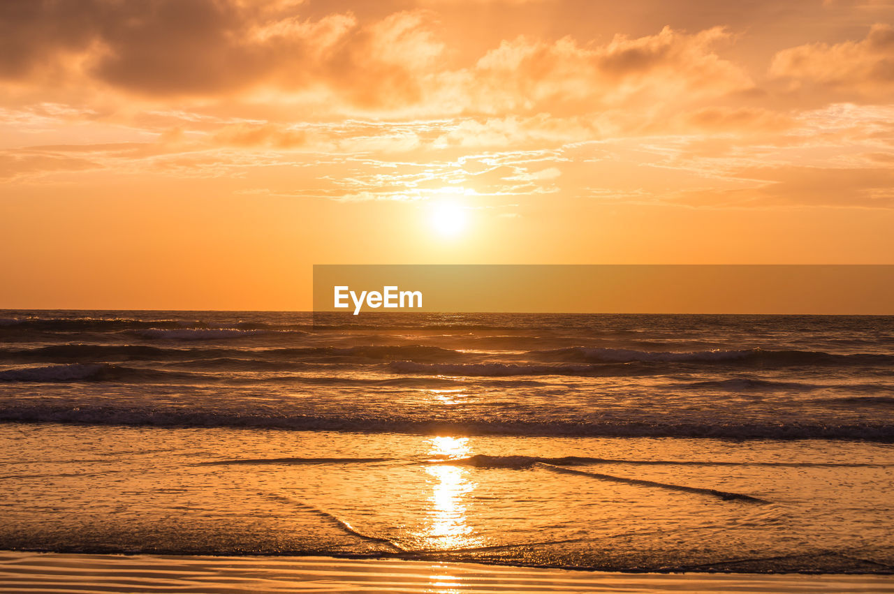 SCENIC VIEW OF SUNSET OVER SEA