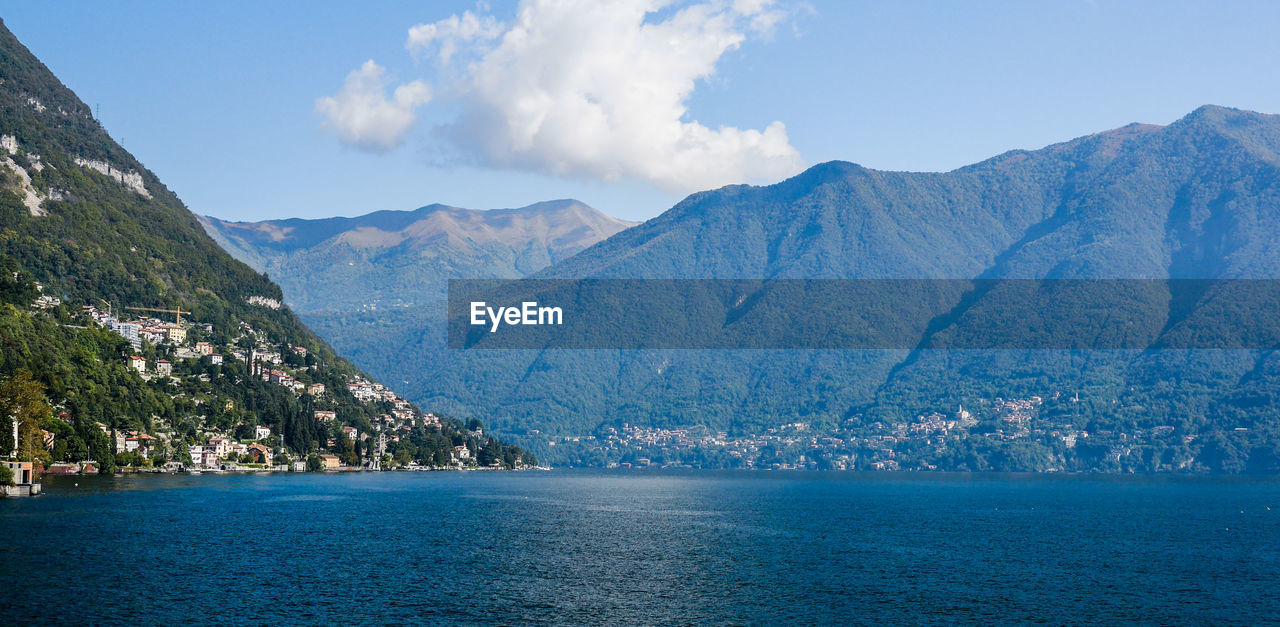 Scenic view of lake como by mountains against sky