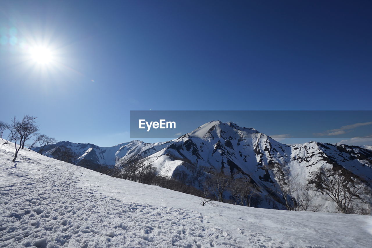 Scenic view of snow mountains against clear sky
