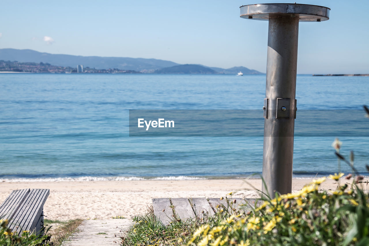 water, sea, coast, shore, nature, ocean, sky, vacation, beauty in nature, land, beach, scenics - nature, body of water, day, bay, tranquility, no people, tranquil scene, plant, clear sky, outdoors, mountain, sunlight, architecture, travel destinations, sunny, blue, idyllic, travel, walkway, horizon, tower, flowering plant, flower