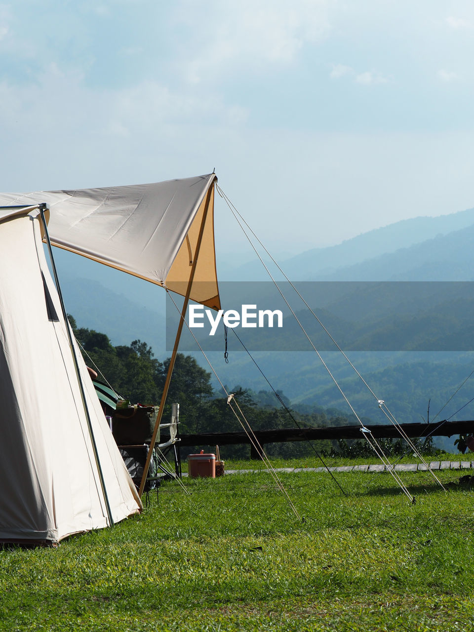 grass, nature, sky, tent, environment, plant, mountain, land, day, beauty in nature, camping, wind, tranquility, landscape, scenics - nature, cloud, no people, outdoors, field, sports, tranquil scene, leisure activity, green, sunlight, travel, non-urban scene, relaxation