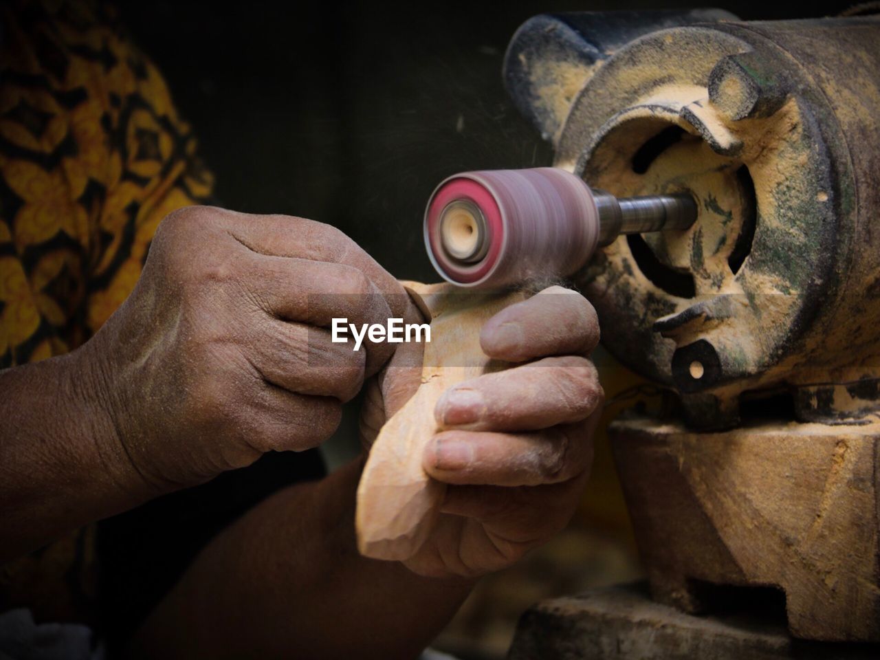 Close-up of man working at machine