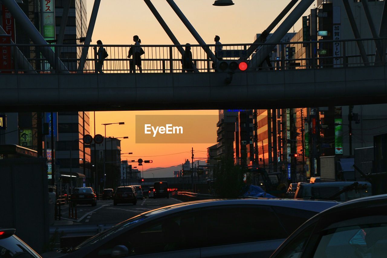 PEOPLE ON CITY STREET AT SUNSET