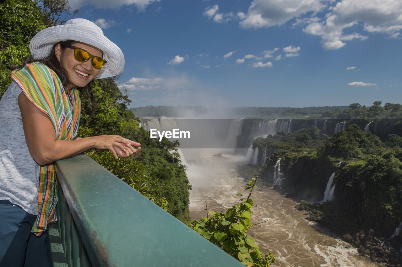 Woman overlooking the iguacu waterfalls in brazil