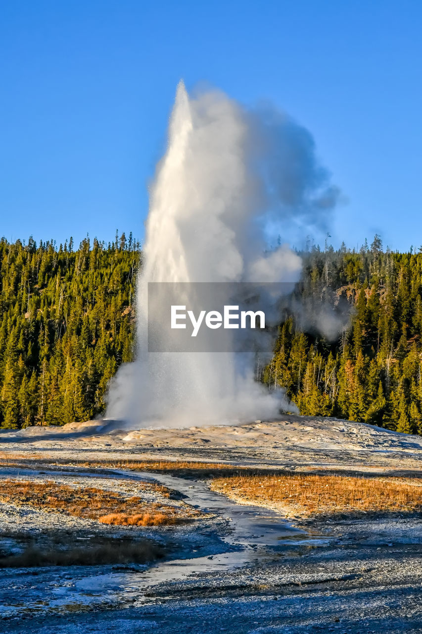 Old faithful geyser in upper geyser basin at yellowstone national park