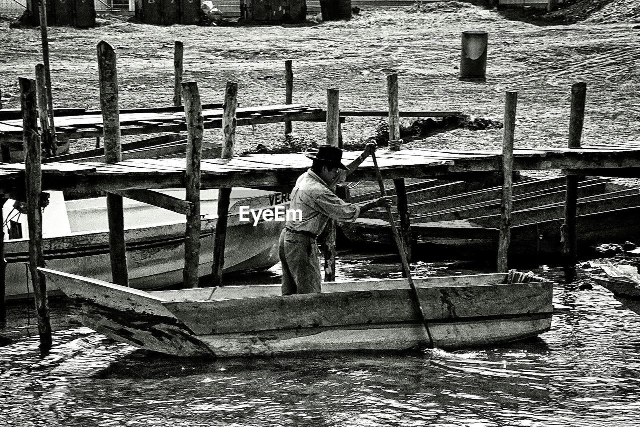 Man rowing boat in sea