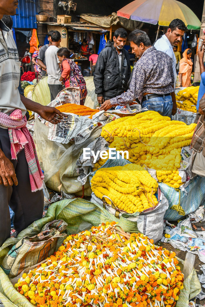 GROUP OF PEOPLE IN MARKET STALL