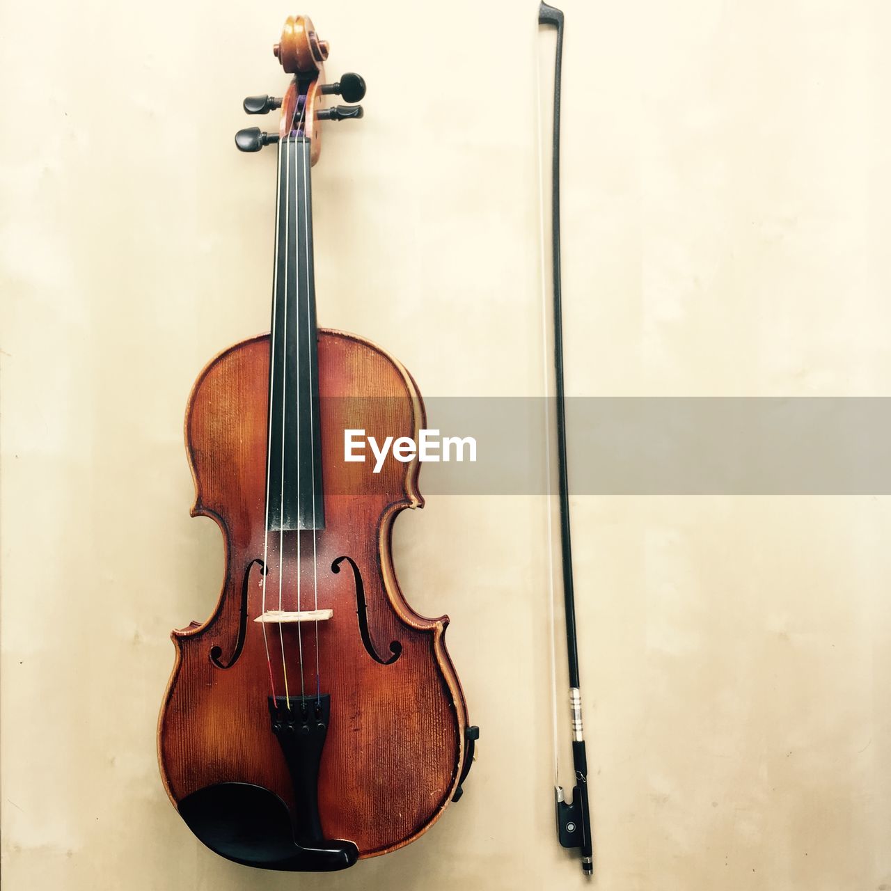 High angle view of violin and bow on table