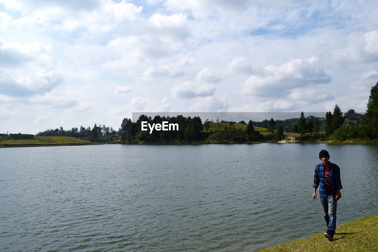 Full length of man on lake against sky