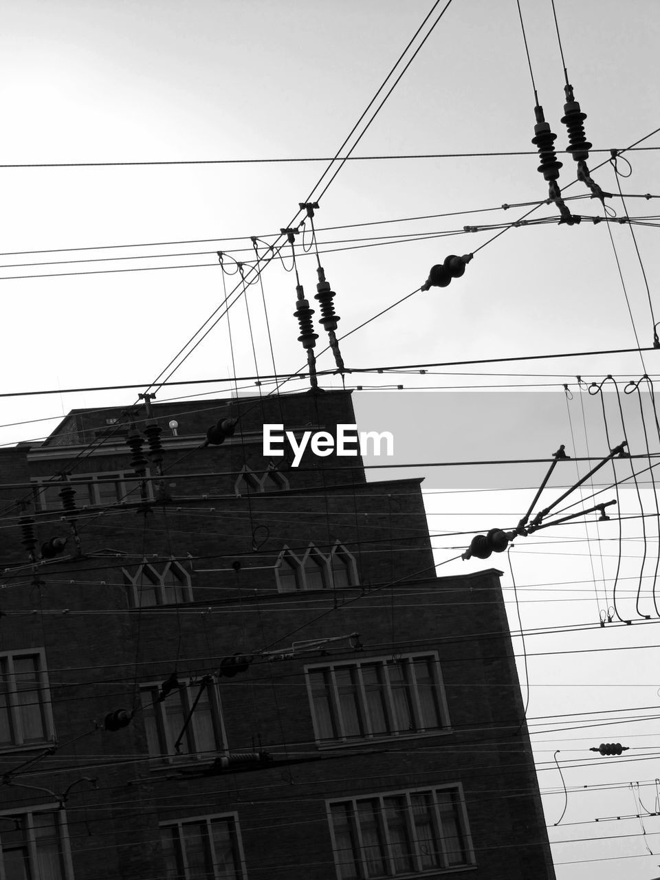 LOW ANGLE VIEW OF ELECTRICITY PYLONS AGAINST SKY