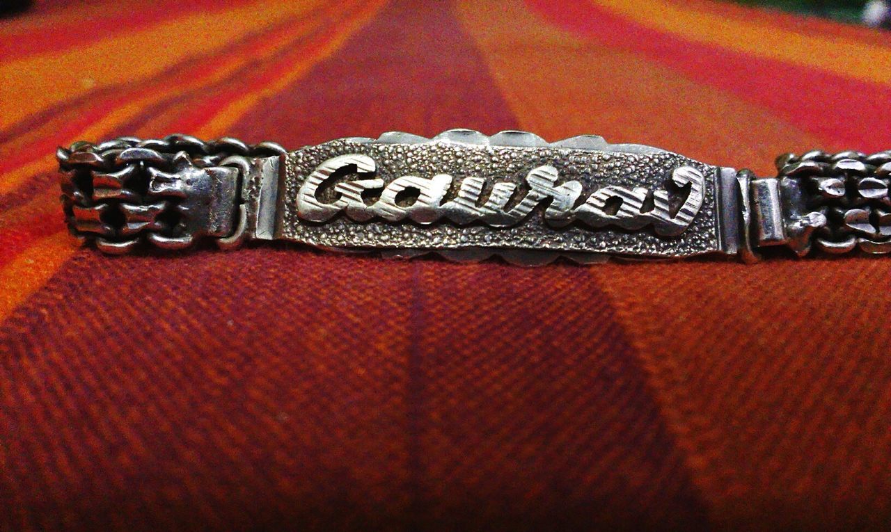 Close-up of text written on bracelet