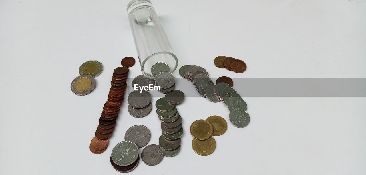 HIGH ANGLE VIEW OF COINS ON PAPER