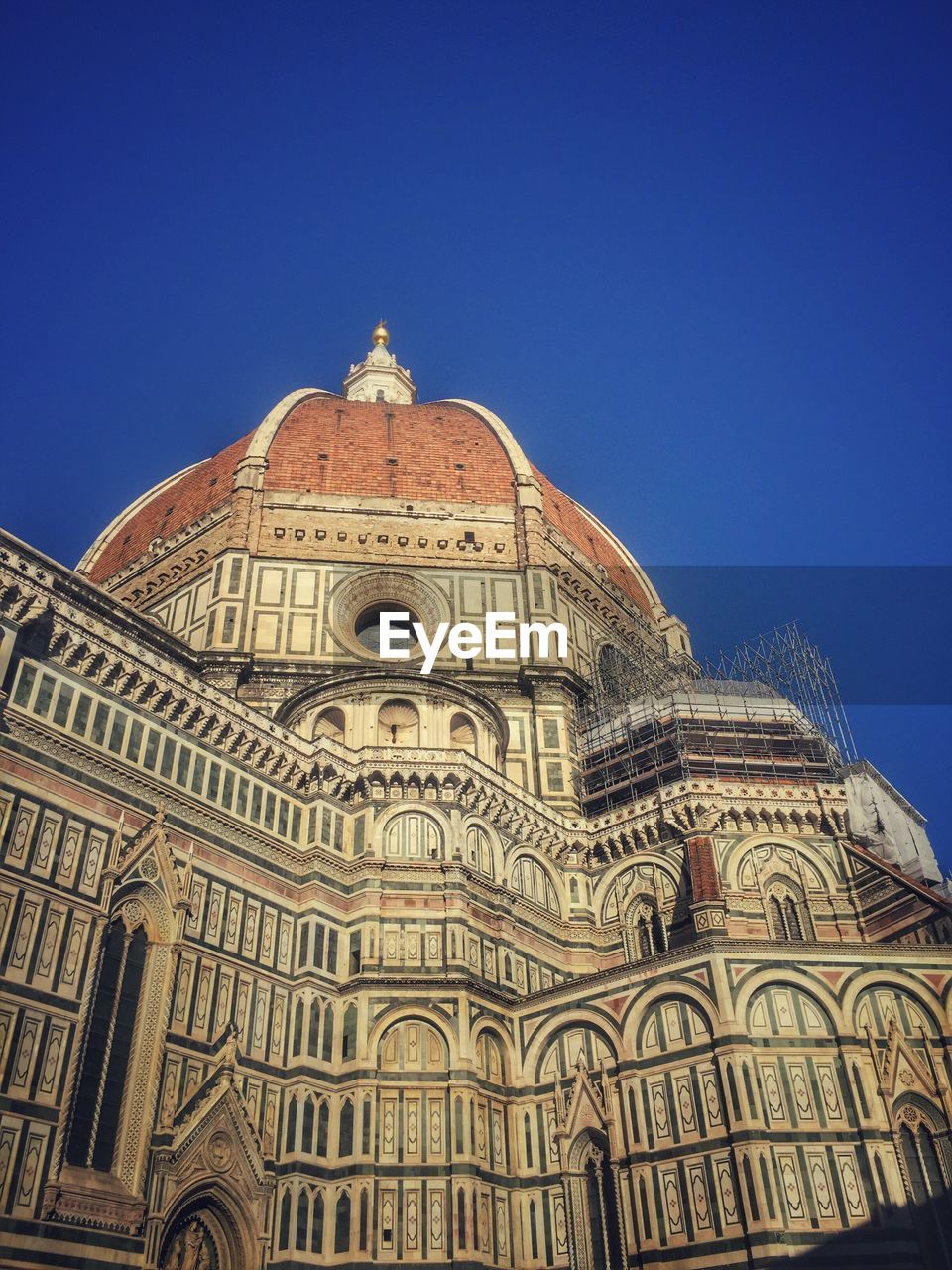 Low angle view of duomo santa maria del fiore against clear blue sky