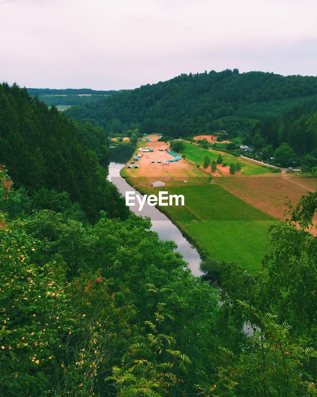 High angle view of river and green field