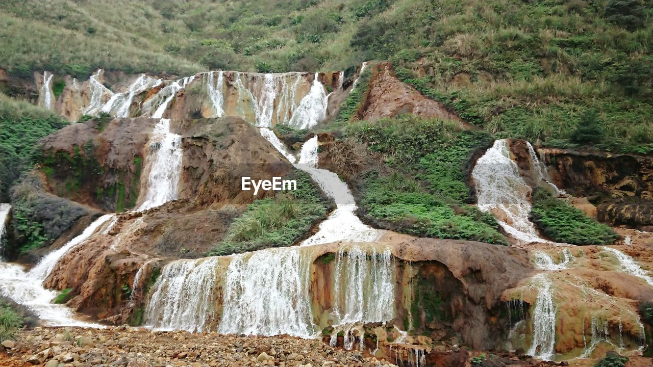 View of waterfall on rock formations