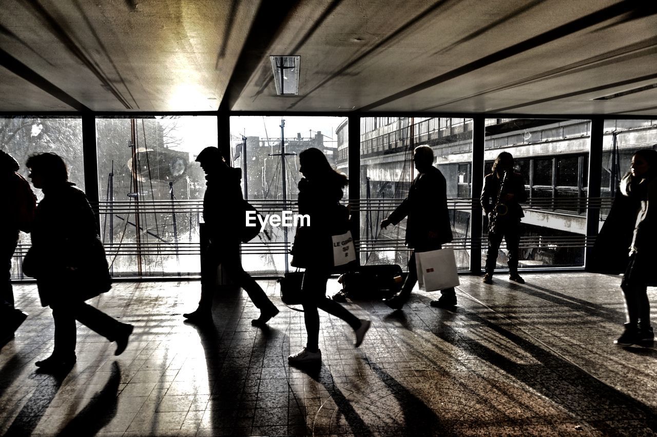 PEOPLE WAITING IN SUBWAY STATION