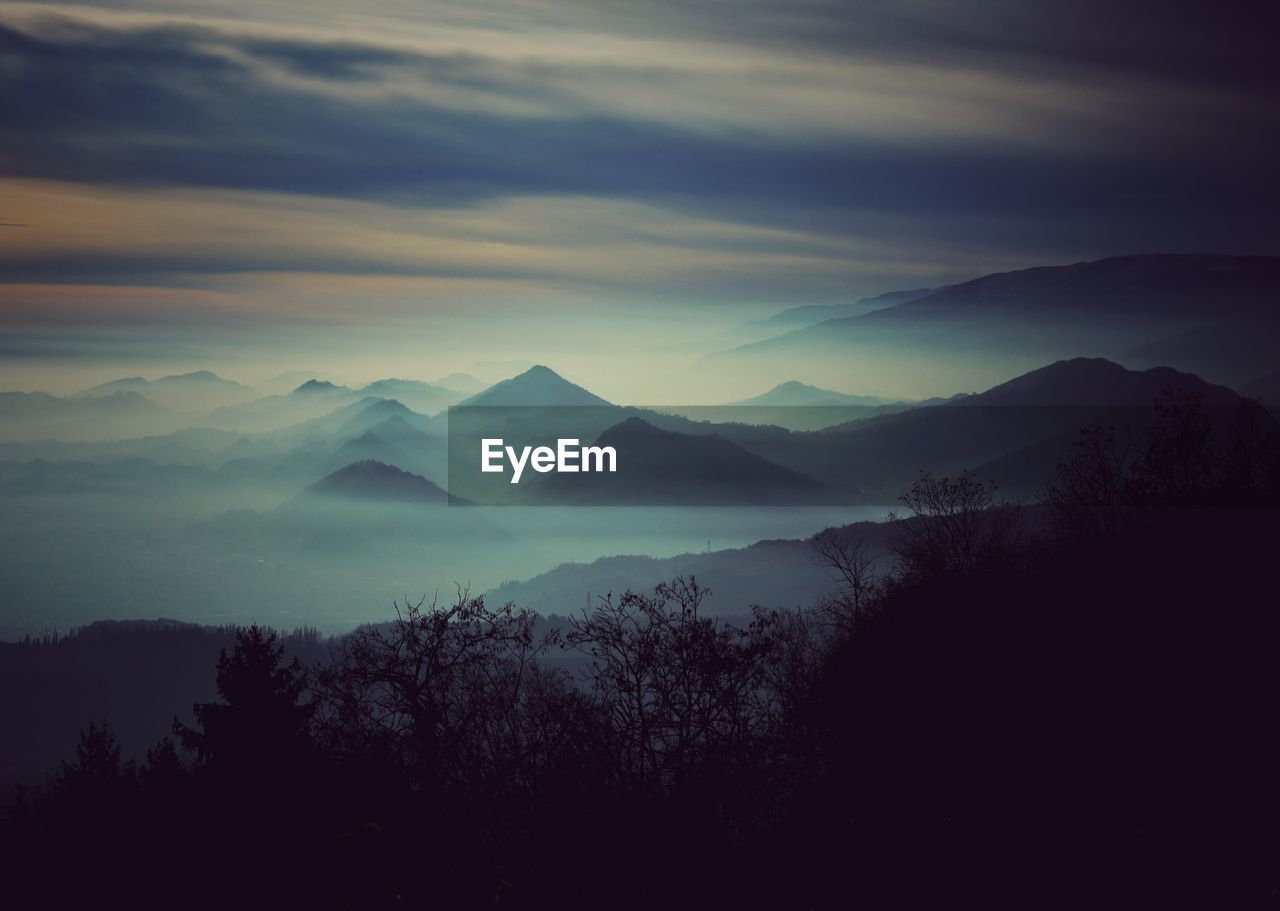 Scenic view of silhouette mountains against sky at sunset
