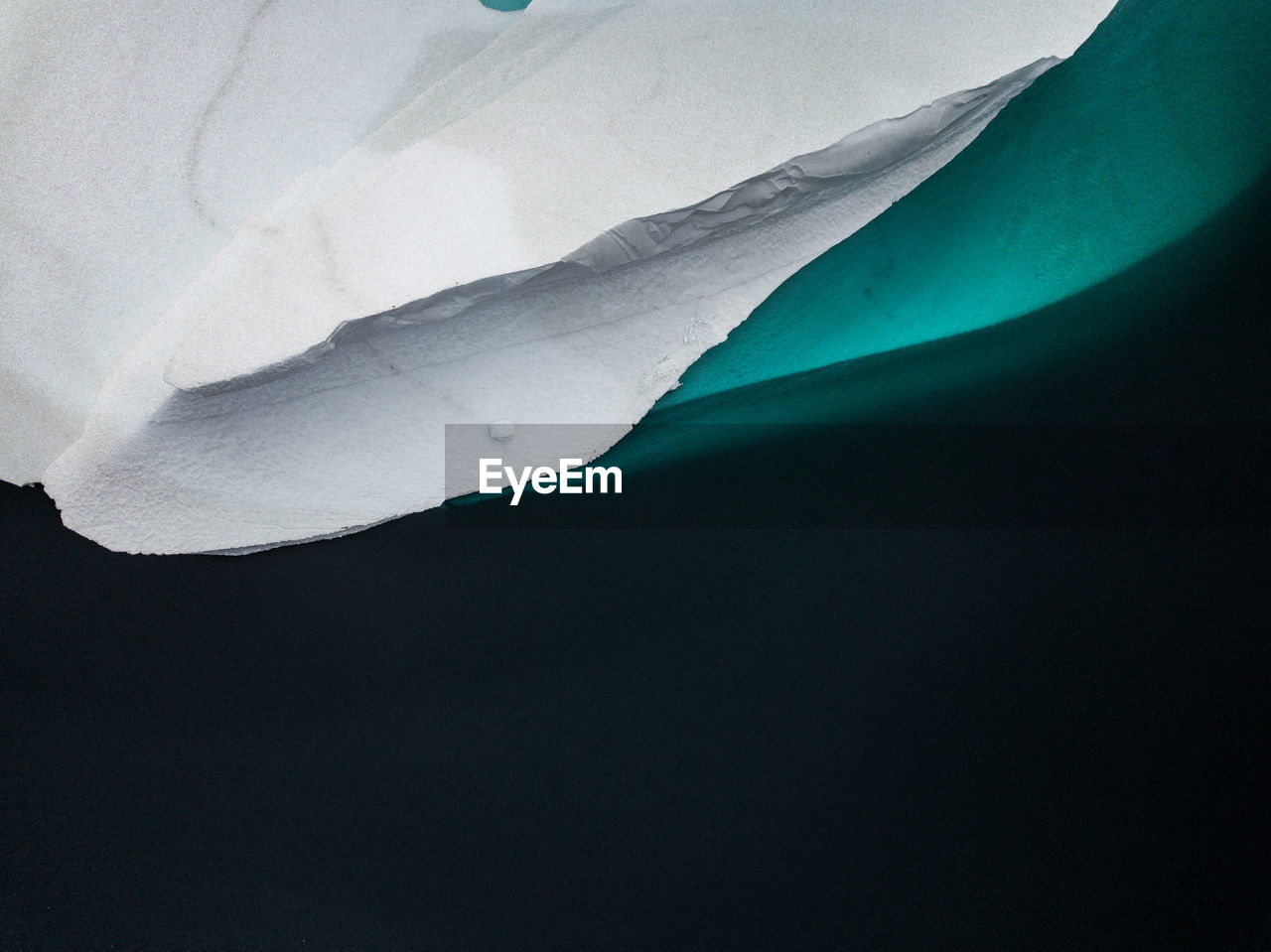 Aerial view of iceberg melting in sea