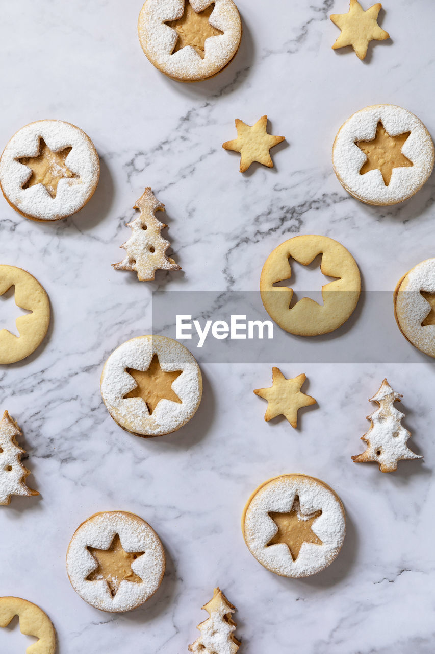 Baking background. traditional linzer christmas cookies with peanut butter on a marble. 