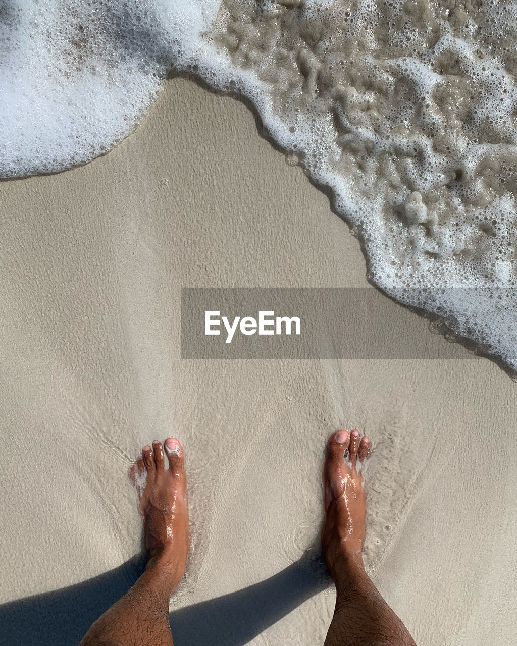 Low section of person on beach on isabela island galapagos 