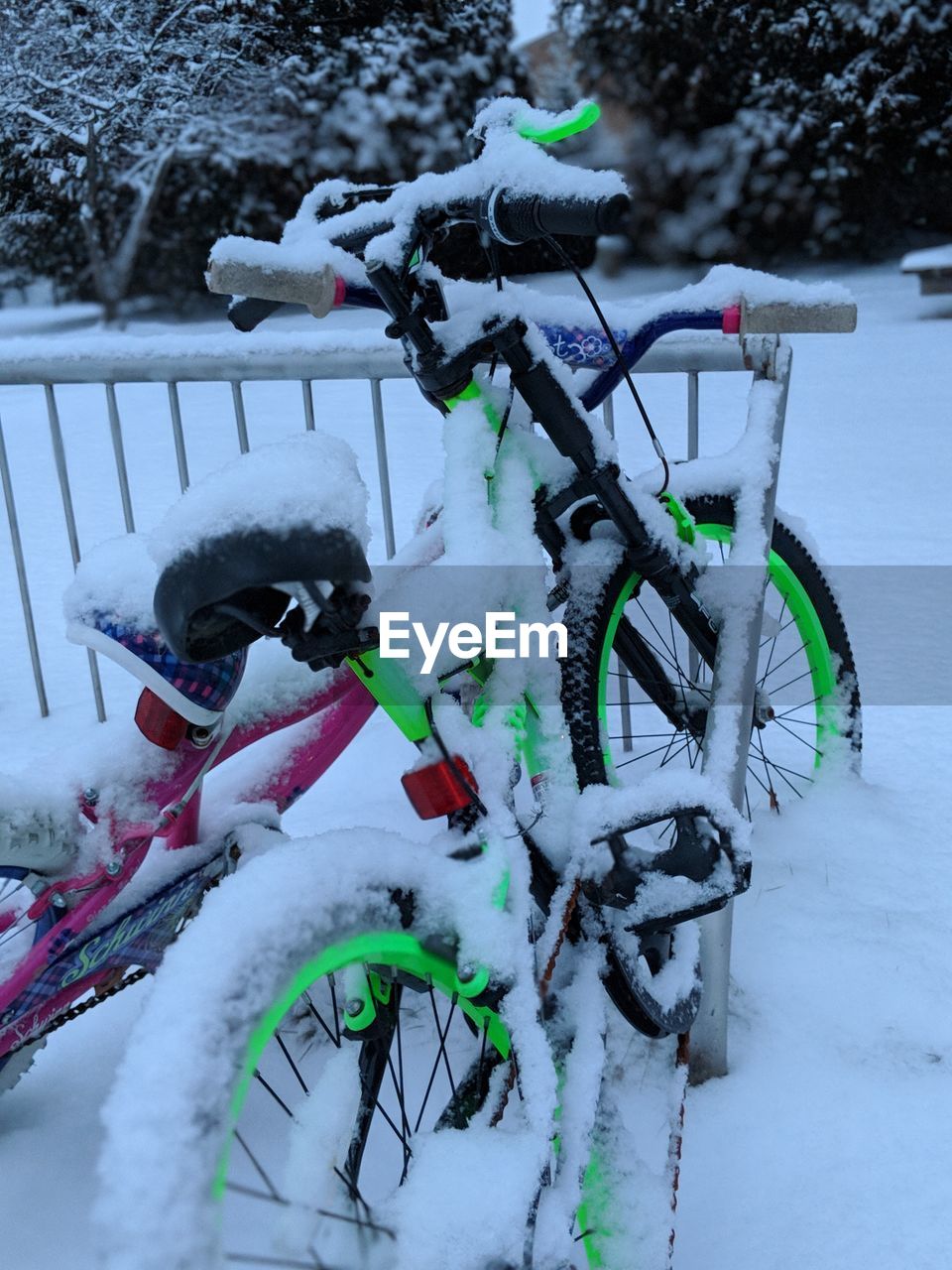 Close-up of snow covered bicycle during winter