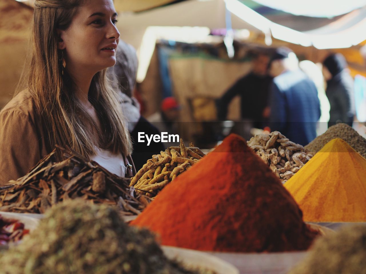 Young woman standing at market stall