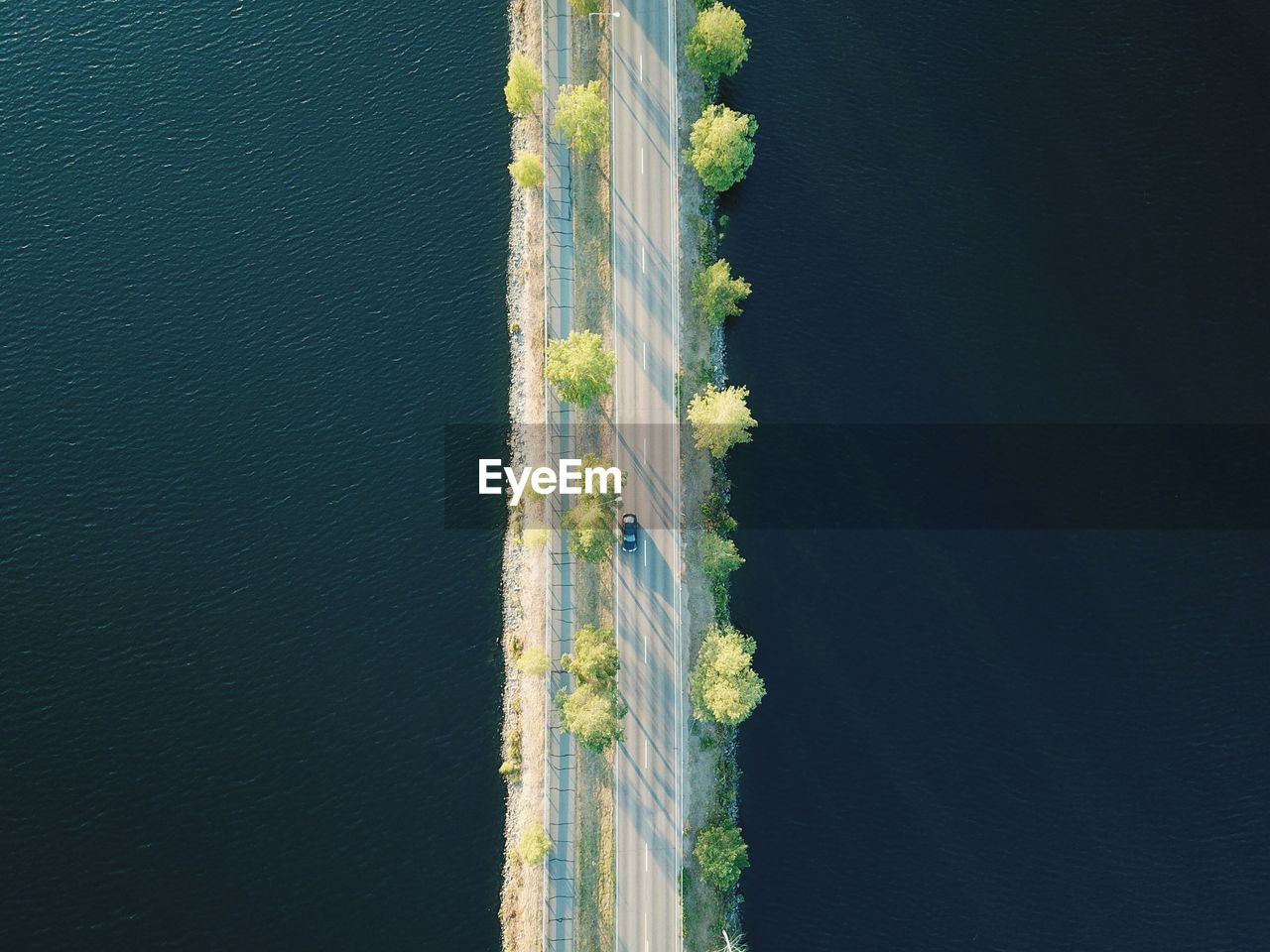 Aerial view of car on bridge by sea