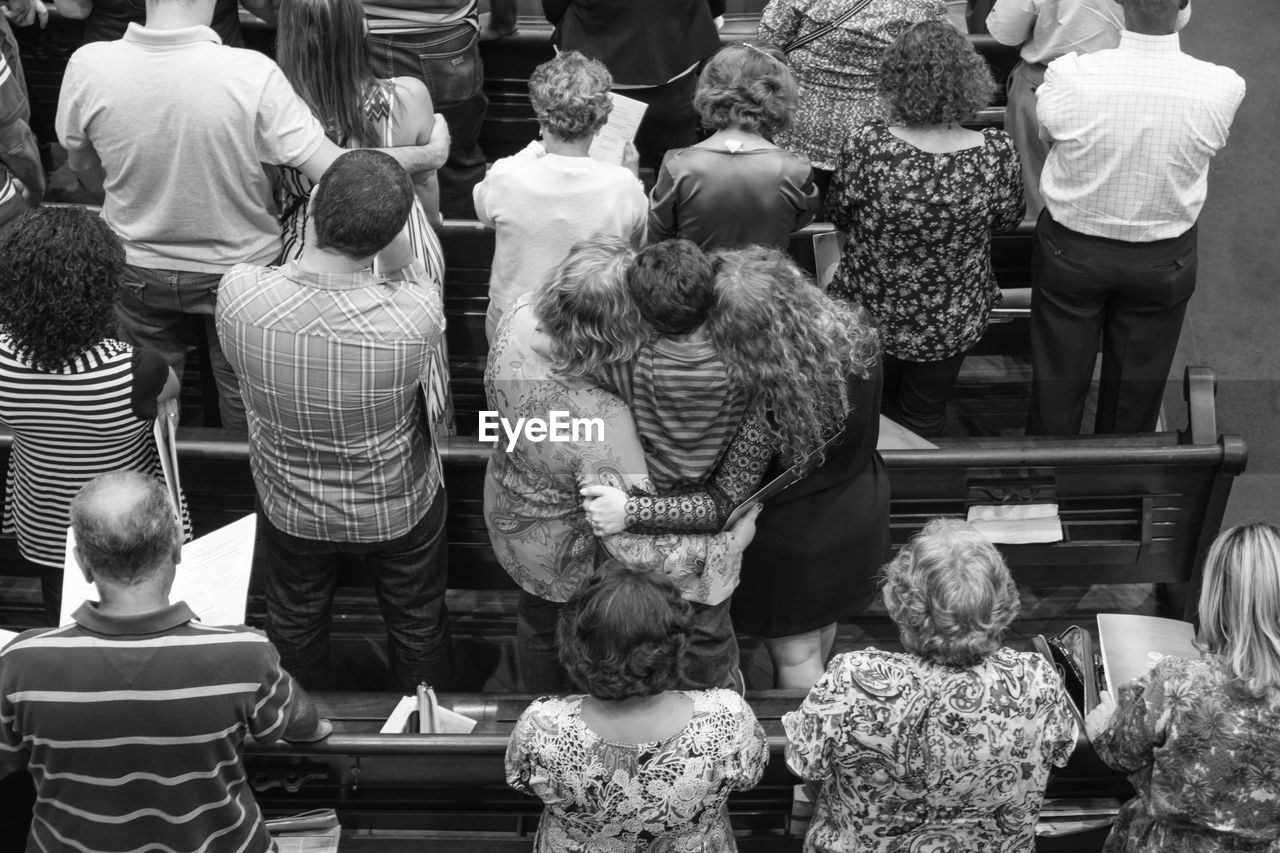 High angle view of people praying at church