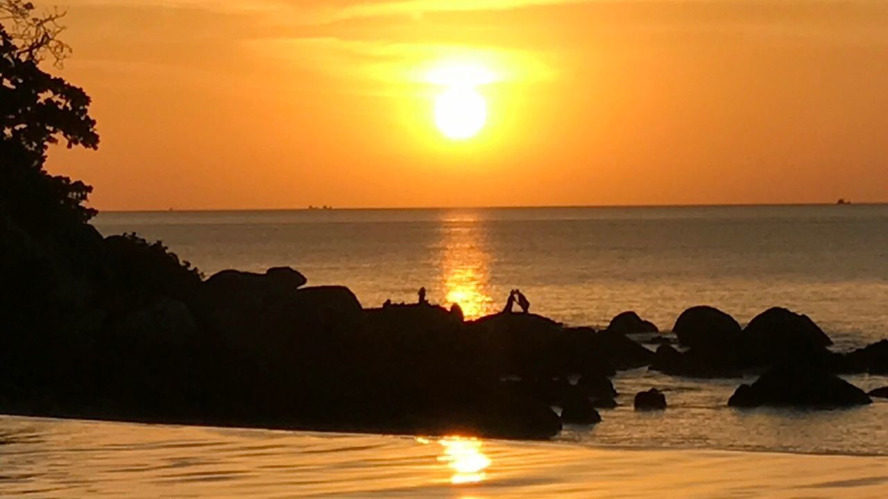 SCENIC VIEW OF SUNSET OVER SEA