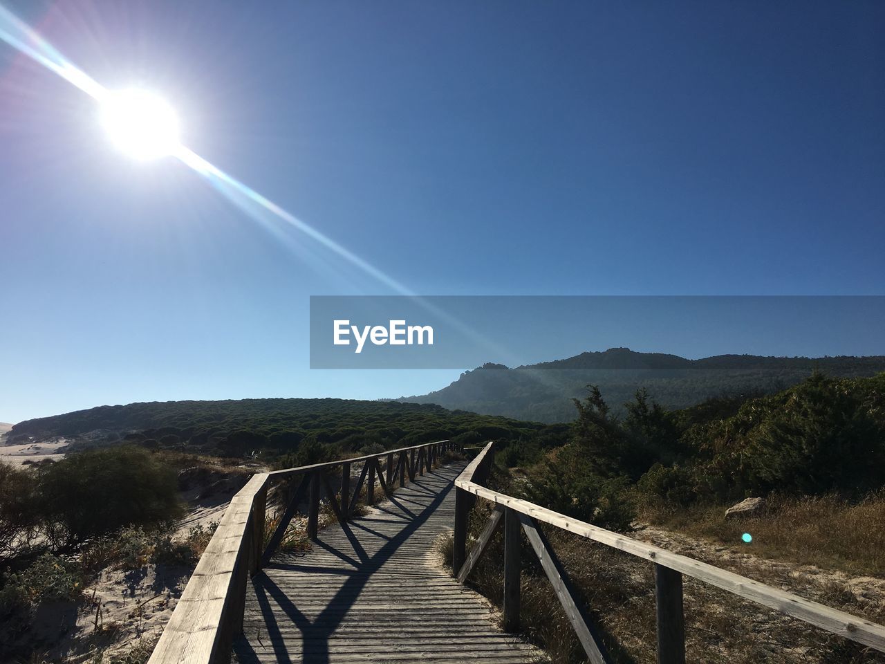 Scenic view of mountains against clear blue sky