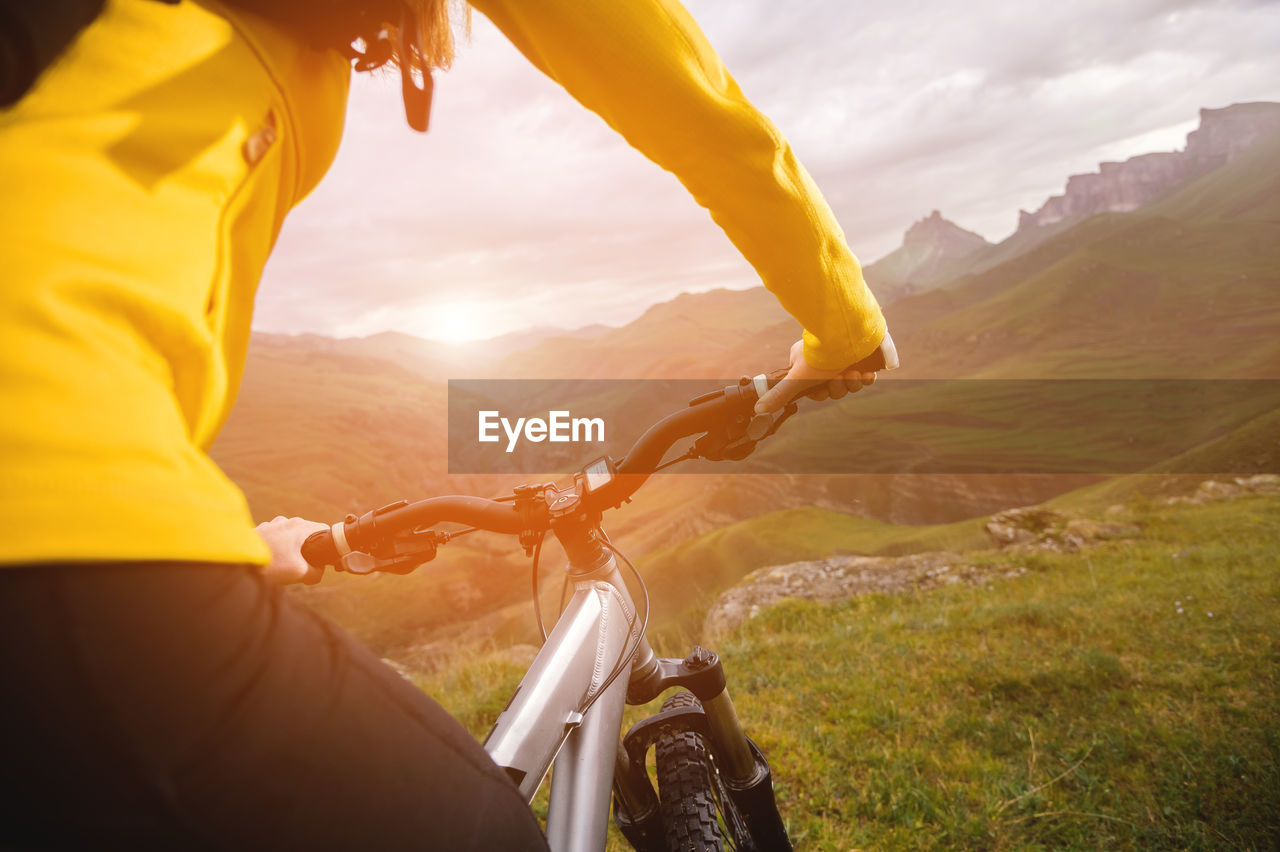 Rear view of man riding motorcycle on landscape