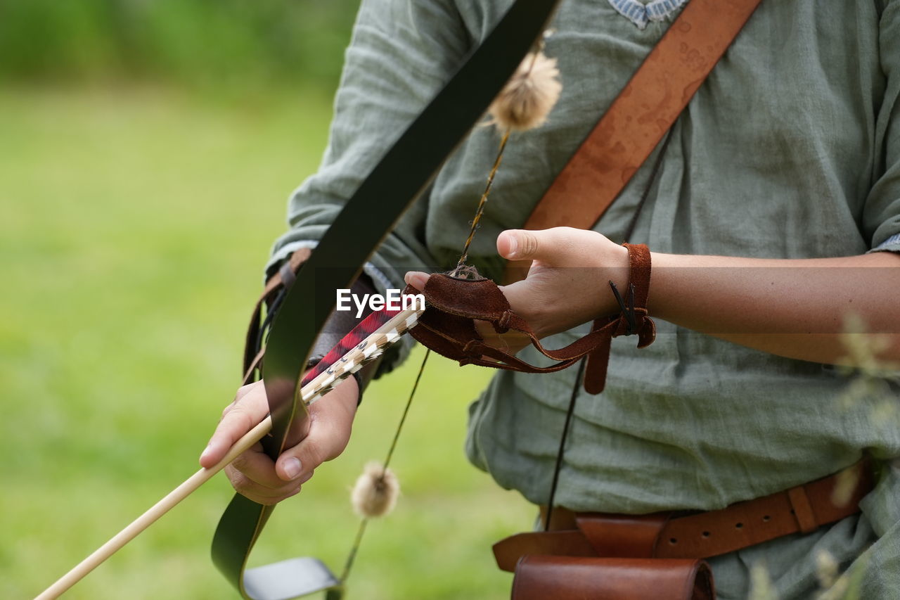 cropped hand of man holding plant