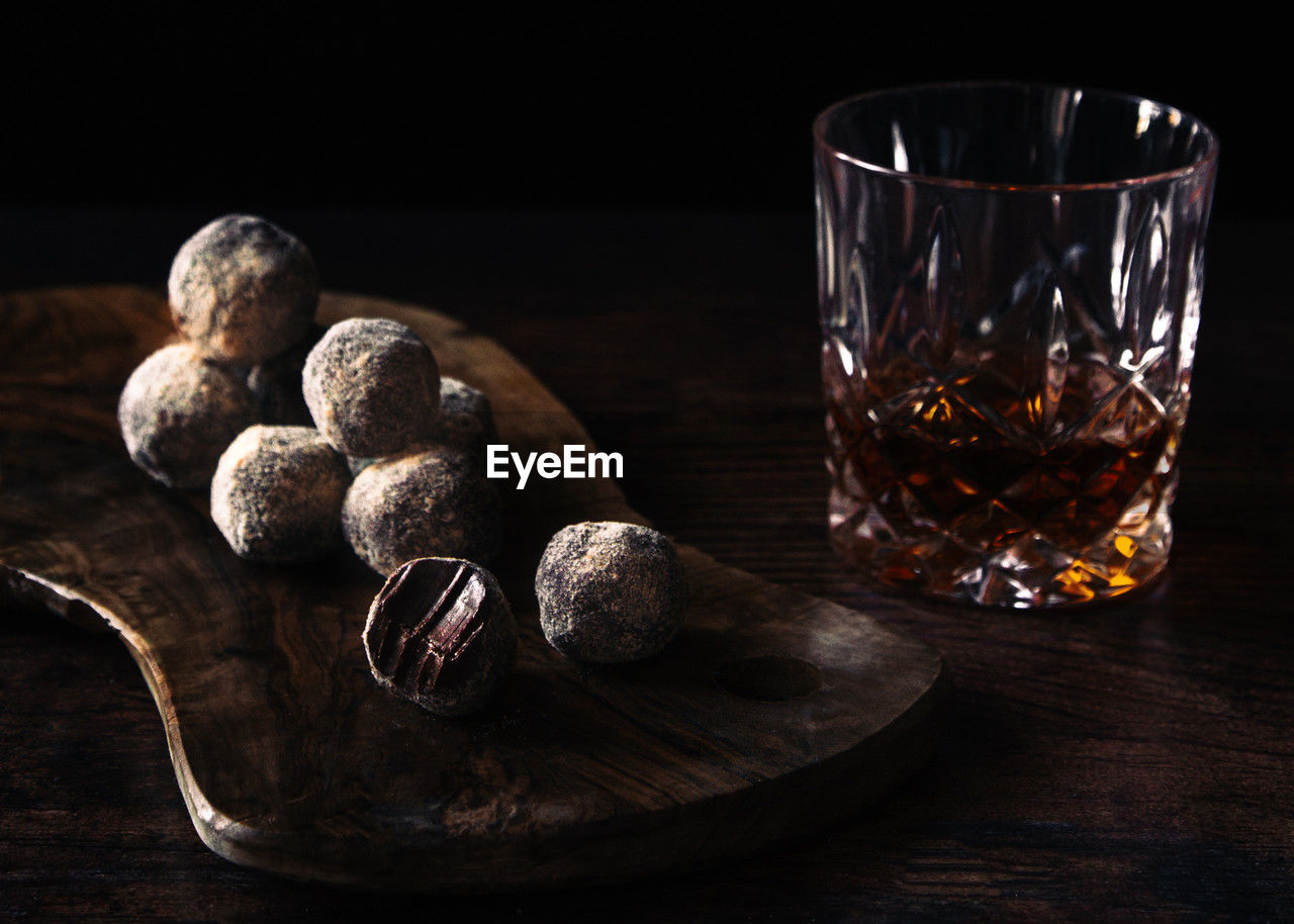 Whisky and chocolate truffles still life